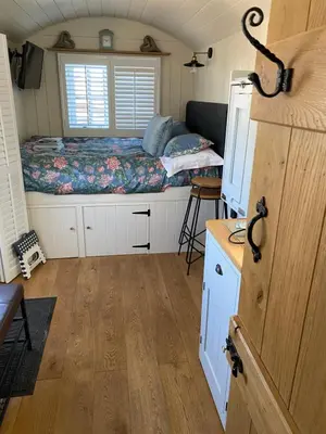 a small room with a bed and a desk at Downsfield Bed and Breakfast in St Ives