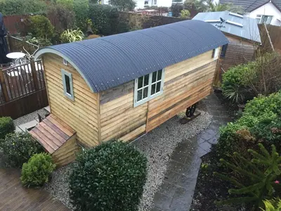 a small house with a solar roof on a garden at Downsfield Bed and Breakfast in St Ives