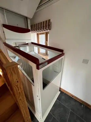 a staircase in a room with glass and wood at The Corn Store in Porthtowan