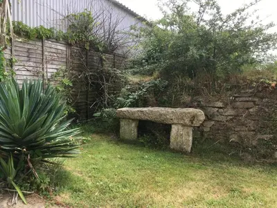 a stone bench sitting next to a stone wall at The Corn Store in Porthtowan