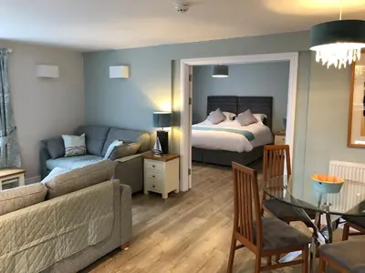 a living room with a bed and a couch at Beacon Country House B & B & Luxury Shepherd Huts in St. Agnes