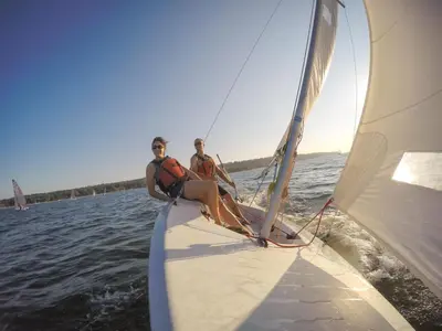 two people sitting on a sail boat on the water at Fal River Cottage in Truro