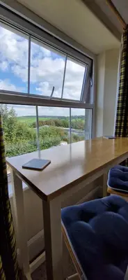a desk in a room with a large window at Sycamore Farm in Launceston