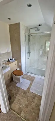 a bathroom with a shower and a toilet and a sink at Sycamore Farm in Launceston