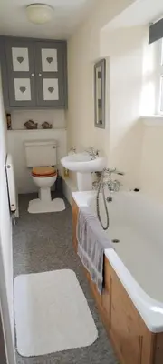 a bathroom with a tub and a sink and a toilet at Sycamore Farm in Launceston