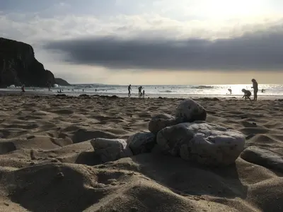 a pile of rocks sitting on a sandy beach at The Byre in Porthtowan