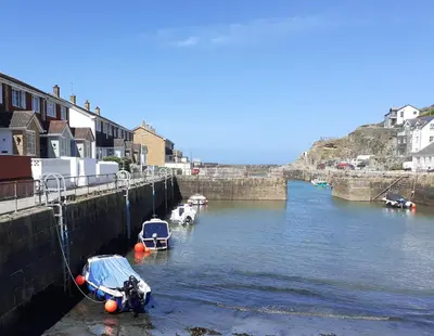 a group of boats are docked in a river at Inner Harbour Cottage in Portreath