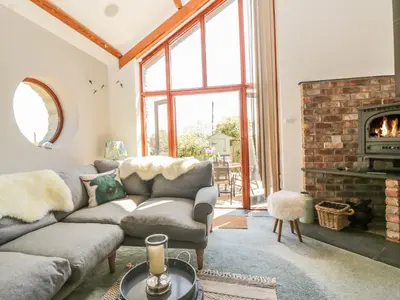 a living room with a couch and a fireplace at The Wagon House in Launceston
