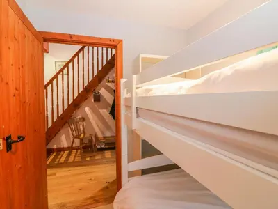 a room with two bunk beds and a staircase at The Wagon House in Launceston