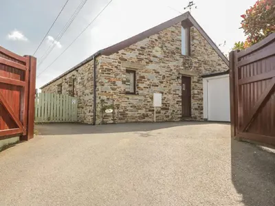 a brick house with a gate and a garage at The Wagon House in Launceston