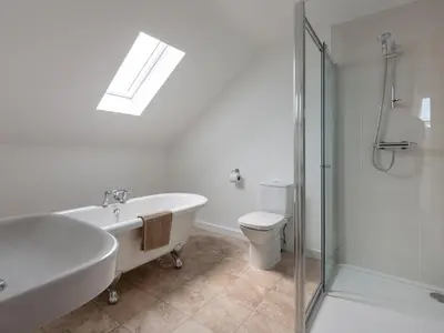 a bathroom with a tub and a toilet and a sink at Rocky Close in St Ives