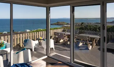 a balcony with a view of the ocean at Rocky Close in St Ives