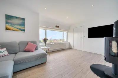 a living room with a couch and a flat screen tv at Chi An Mor in Newquay