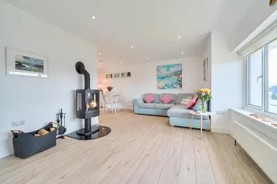 a living room with a fireplace and a couch at Chi An Mor in Newquay