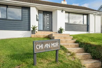 a sign in front of a house at Chi An Mor in Newquay