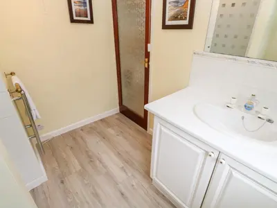 a bathroom with a white sink and a mirror at Trevow in Camborne