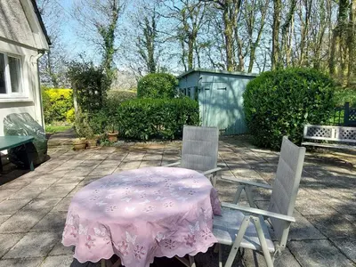 a table and chairs with a pink table cloth on it at Trevow in Camborne