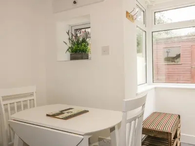 a kitchen with a white counter and a window at Little Prickle in Newquay