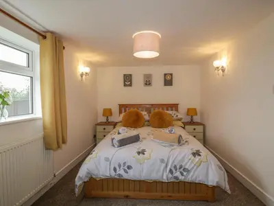 a bedroom with a bed with two teddy bears on it at Little Prickle in Newquay