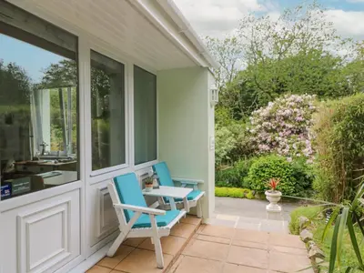 a patio with two chairs and a table on a house at Lighthouse in Penzance