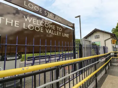 a sign that reads welcome to the lodge valley line at Lowena Cottage in Looe