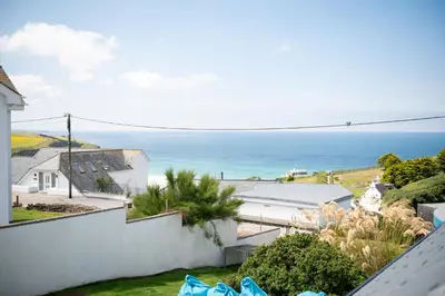 a view of the ocean from the balcony of a house at Blue Bay Beach House in Newquay
