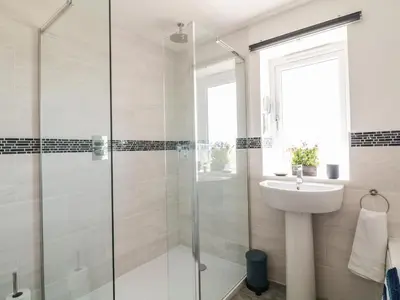 a bathroom with a shower and a sink at Ocean Breeze in Marazion