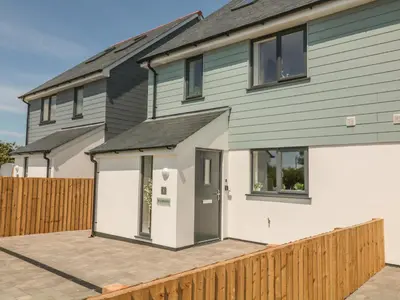 a house with a large driveway in front of it at Ocean Breeze in Marazion