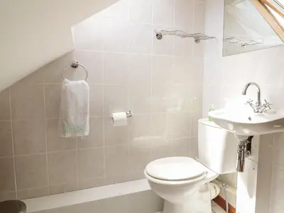 a bathroom with a toilet and a sink at Woodside Barns in St Austell