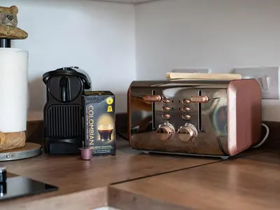a toaster oven sitting on a counter next to a book at Bear Cottage in Truro