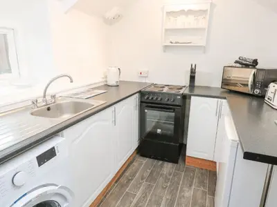 a kitchen with a sink and a dishwasher at Toadstools in Penryn