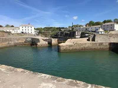 a large body of water with buildings in the background at Starfish Cottage- private beach access- dog friendly in Charlestown