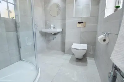 a bathroom with a toilet and a sink and a shower at Sunnyside Barn in Truro