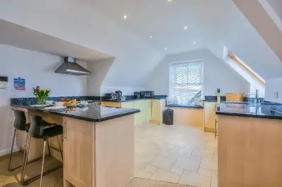a large kitchen with a large island in a room at Trevail Penthouse in St Ives