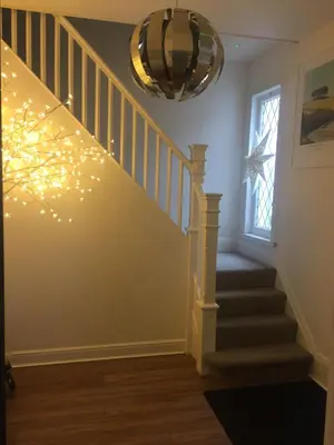 a hallway with stairs with christmas lights at Alderberry Lodge in Newquay