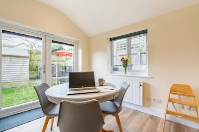a room with a table with a laptop on it at Cornish Holiday - Meadow Rise in Saint Columb Major