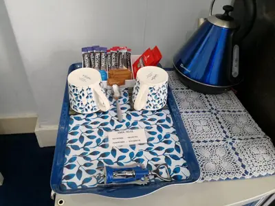 a table with a blue and white table cloth on it at Arches B&B in St Austell