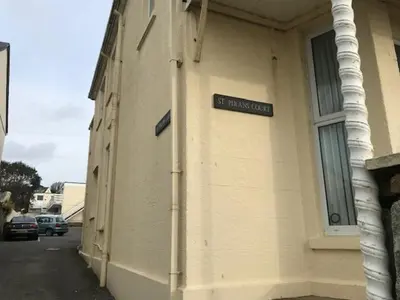 a street sign on the side of a building at Sandpiper, apartment across from the beach in Marazion