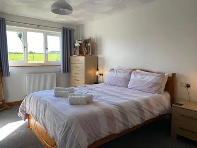 a bedroom with a bed with two towels on it at Buena Vista in Tintagel