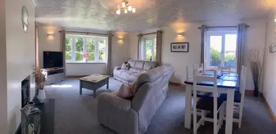 a living room with a couch and a table at Buena Vista in Tintagel