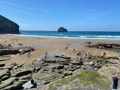 a group of people on a beach near the ocean at Buena Vista in Tintagel