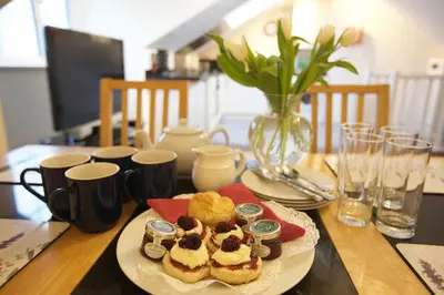 a table with a plate of desserts on a table at Waterfall Cottage in Launceston