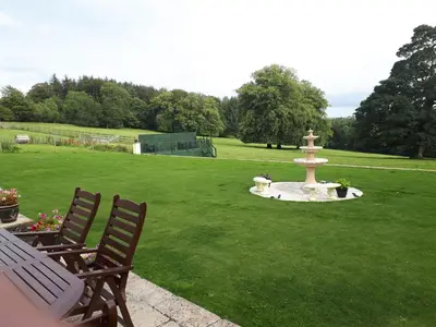a park with a fountain in the middle of a lawn at Waterfall Cottage in Launceston