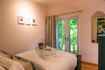a room with a bed and a table with a window at THE HYDE- secret hide away, near the beach. in Truro