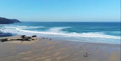two people standing on a beach near the ocean at THE HYDE- secret hide away, near the beach. in Truro