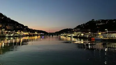 a harbor with boats in the water at night at Lanescot, Harbour View With Terrace in Looe