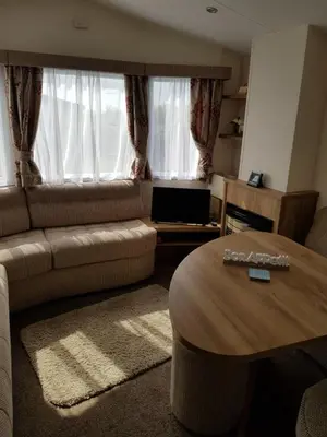 a living room with a couch and a coffee table at Caravan Willerby Gold Star in Looe