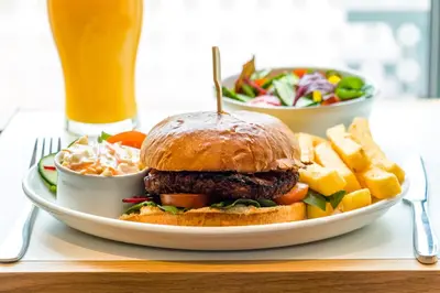 a plate of food with a hamburger and a salad at Holiday Inn Express - Bodmin - Victoria Junction by IHG in Bodmin