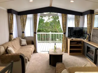 a living room with a couch and a television at Newquay Blue Water in Newquay