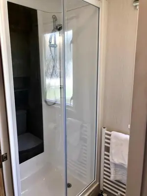 a shower with a glass door in a bathroom at Newquay Blue Water in Newquay